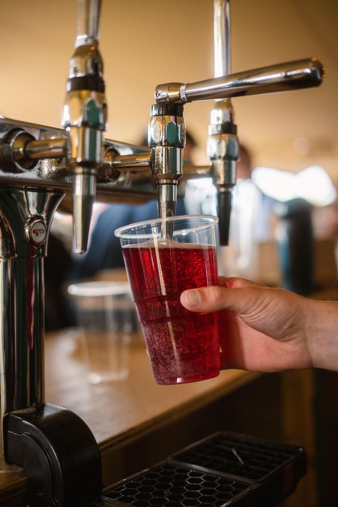 Bar team member pouring cider