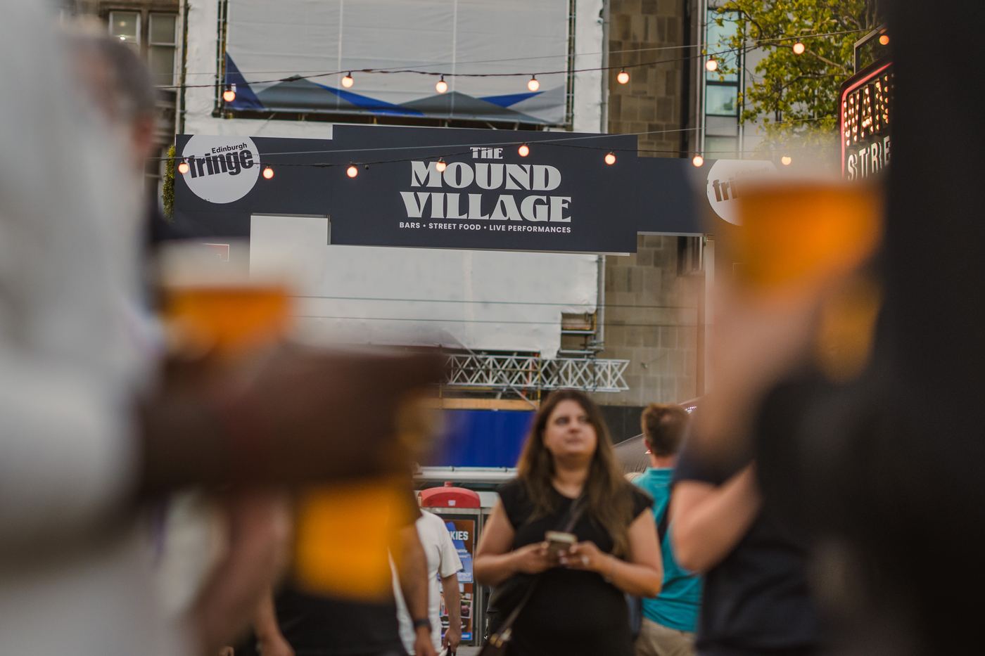 Pints raised under the Mound Village arch