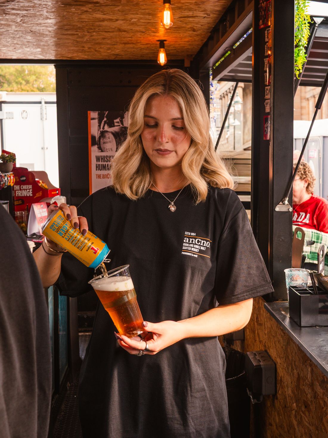 Apex bar team member pouring a pint