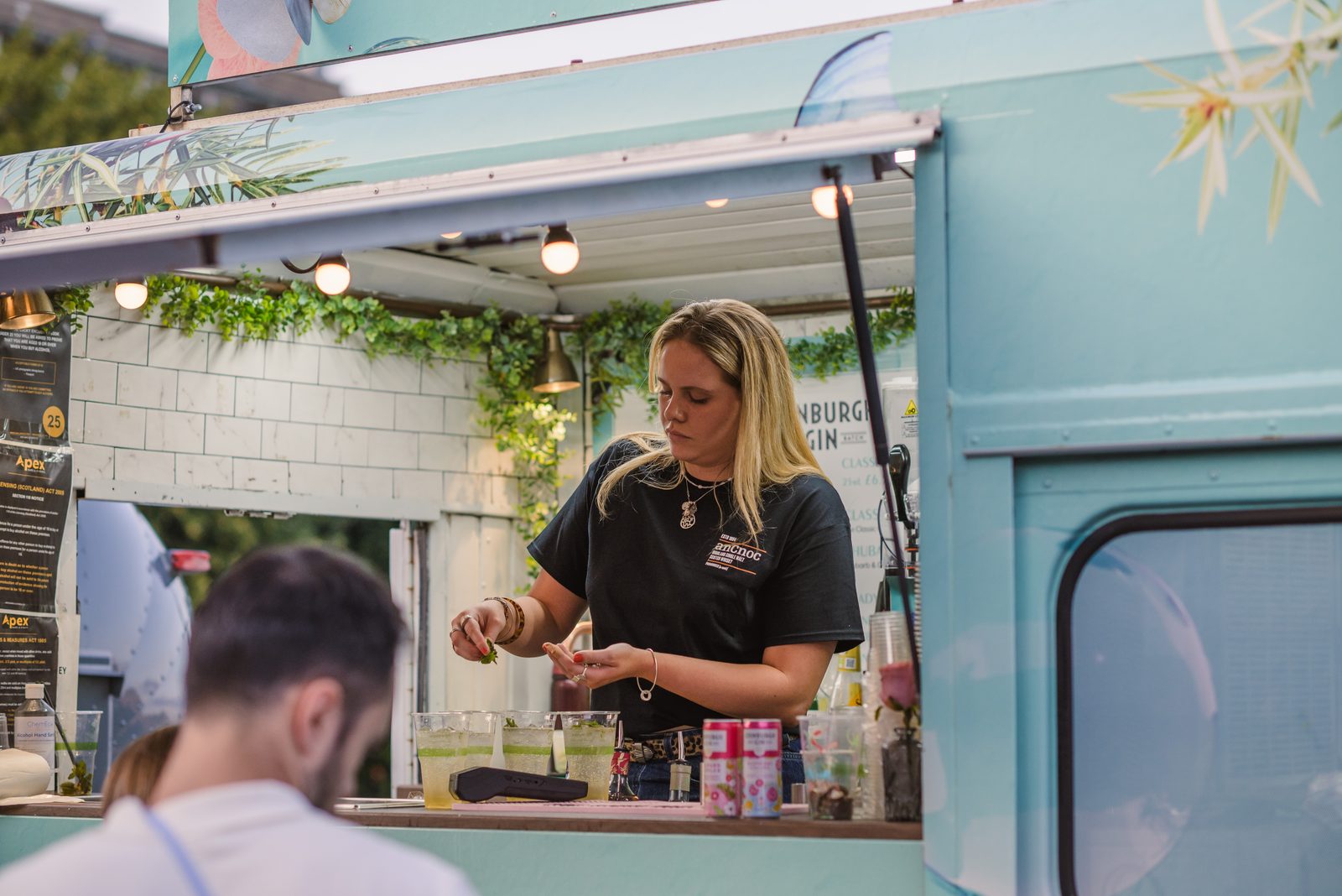 Bar staff serving from a converted van bar